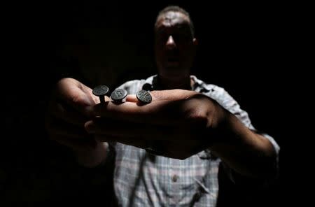 Palestinian carpenter Marwan Shahwan displays what he says are ancient objects from the British era, in Khan Younis in the southern Gaza Strip June 18, 2018. Picture taken June 18, 2018. REUTERS/Ibraheem Abu Mustafa