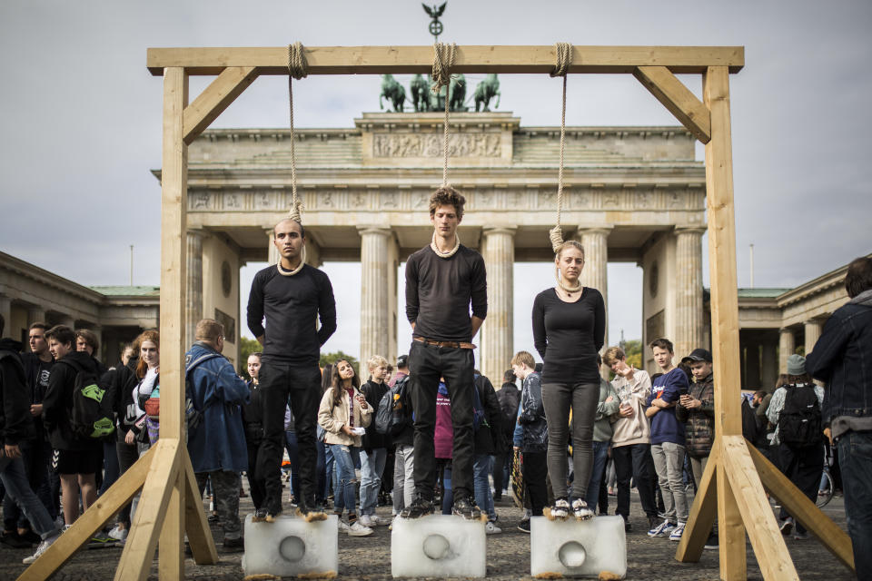 Protesters on a gallow standing on ice are pictured within the worldwide movement 'Fridays for Future' near the Brandenburg Gate on September 20, 2019 in Berlin, Germany.  (Photo: Florian Gaertner/Photothek via Getty Images)