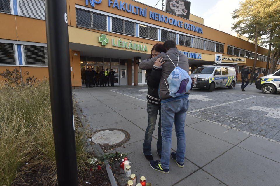 People embrace outside the Ostrava Teaching Hospital after a shooting incident in Ostrava, Czech Republic, Tuesday, Dec. 10, 2019. Police and officials say six people have been killed in a shooting in a hospital in the eastern Czech Republic. Two others are seriously injured. (Jaroslav Ozana/CTK via AP)