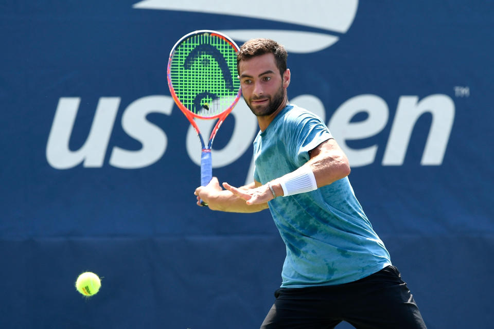 Noah Rubin hits the tennis ball during a match.