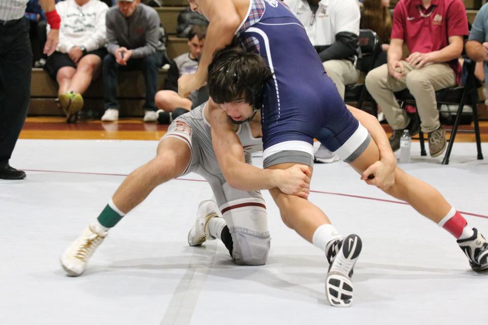 Lake Gibson's Hayden Whidden, pictured here in the grey singlet, placed first after defeating Lake Highland Prep's Luis Bazan in a 6-4 decision.
(Photo: Jackie Emerson