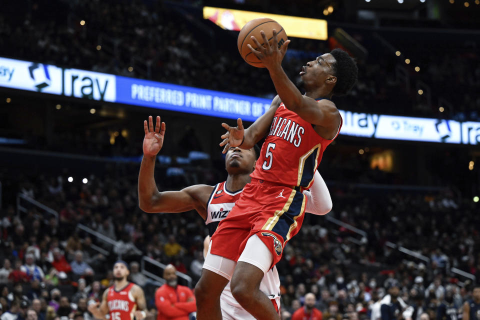 New Orleans Pelicans forward Herbert Jones (5) goes to the basket against Washington Wizards forward Rui Hachimura for a layup during the second quarter of an NBA basketball game, Monday, Jan. 9, 2023, in Washington. (AP Photo/Terrance Williams)