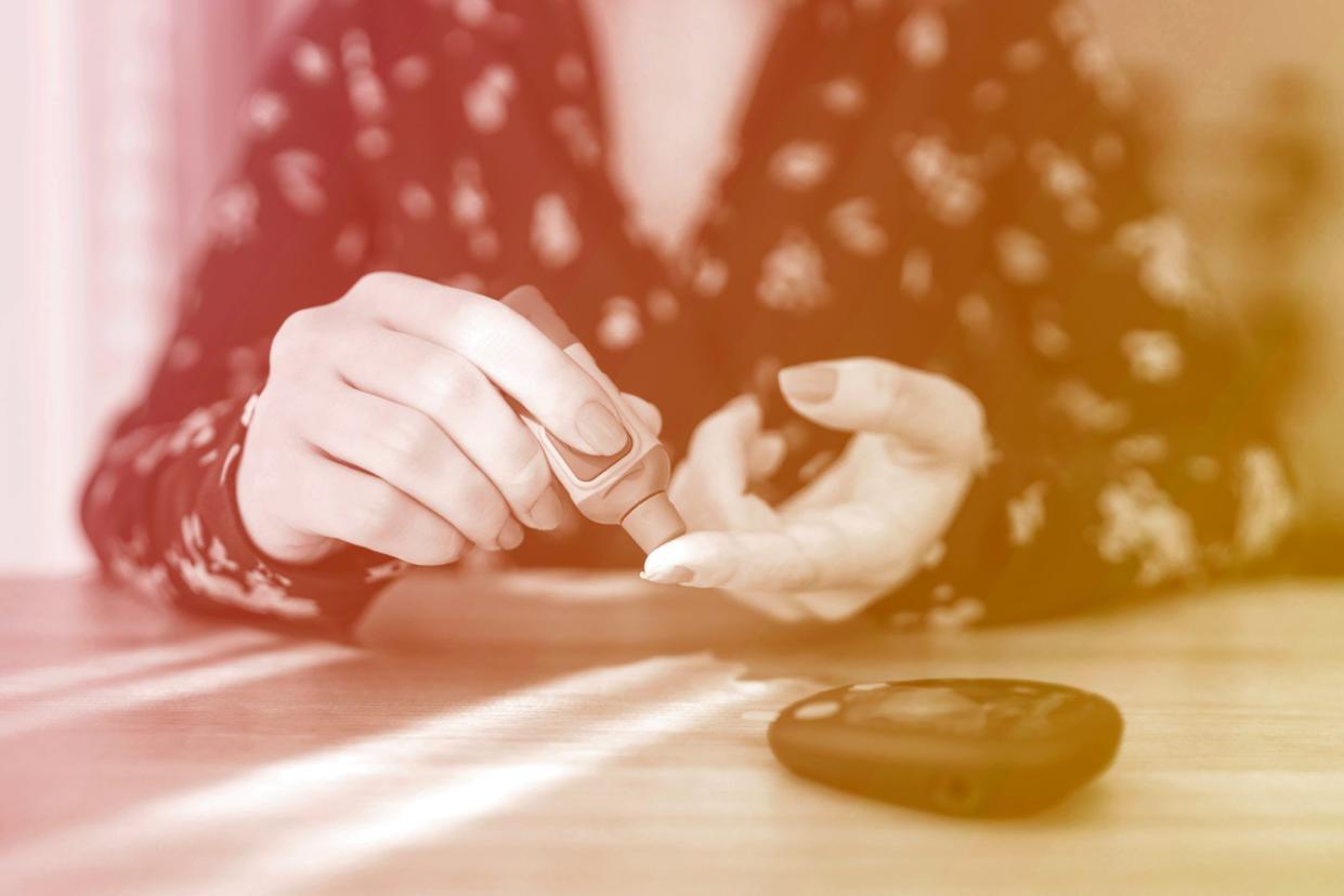 woman testing her blood glucose