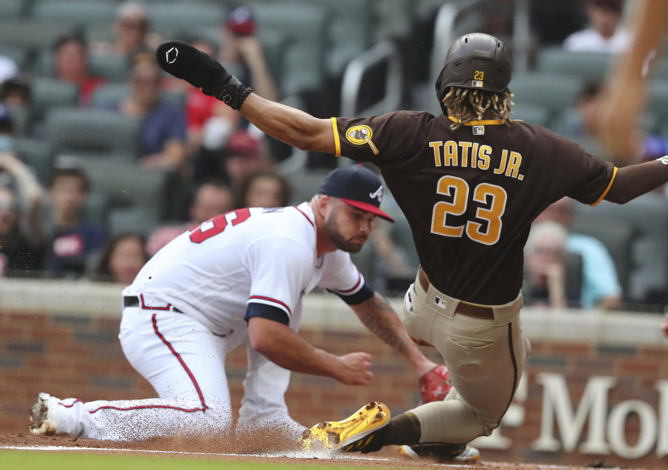 San Diego Padres' Fernando Tatis Jr. scores on a wild pitch past Atlanta Braves starting pitcher Bryse Wilson during the first inning in the second baseball game of a doubleheader Wednesday, July 21, 2021, in Atlanta. (Curtis Compton/Atlanta Journal-Constitution via AP)