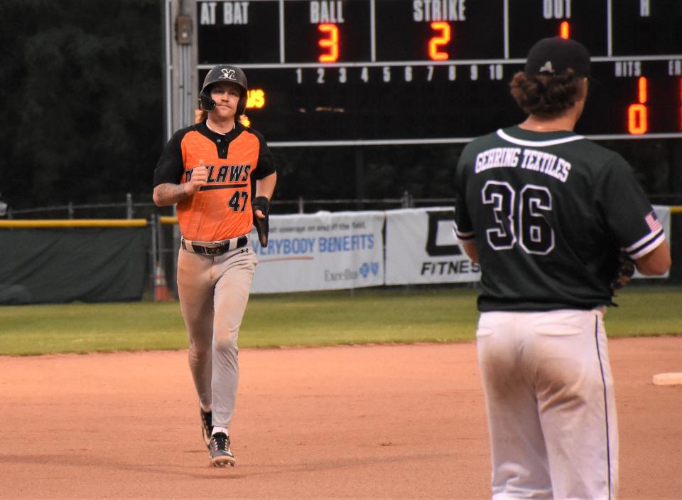 Oneonta Outlaw Dakota Britt (left) approaches third base and Mohawk Valley DiamondDawg Chance Checca, his teammate on Herkimer College's 2022 NJCAA Division III championship team, during the second game of Friday, doubleheader in Little Falls.