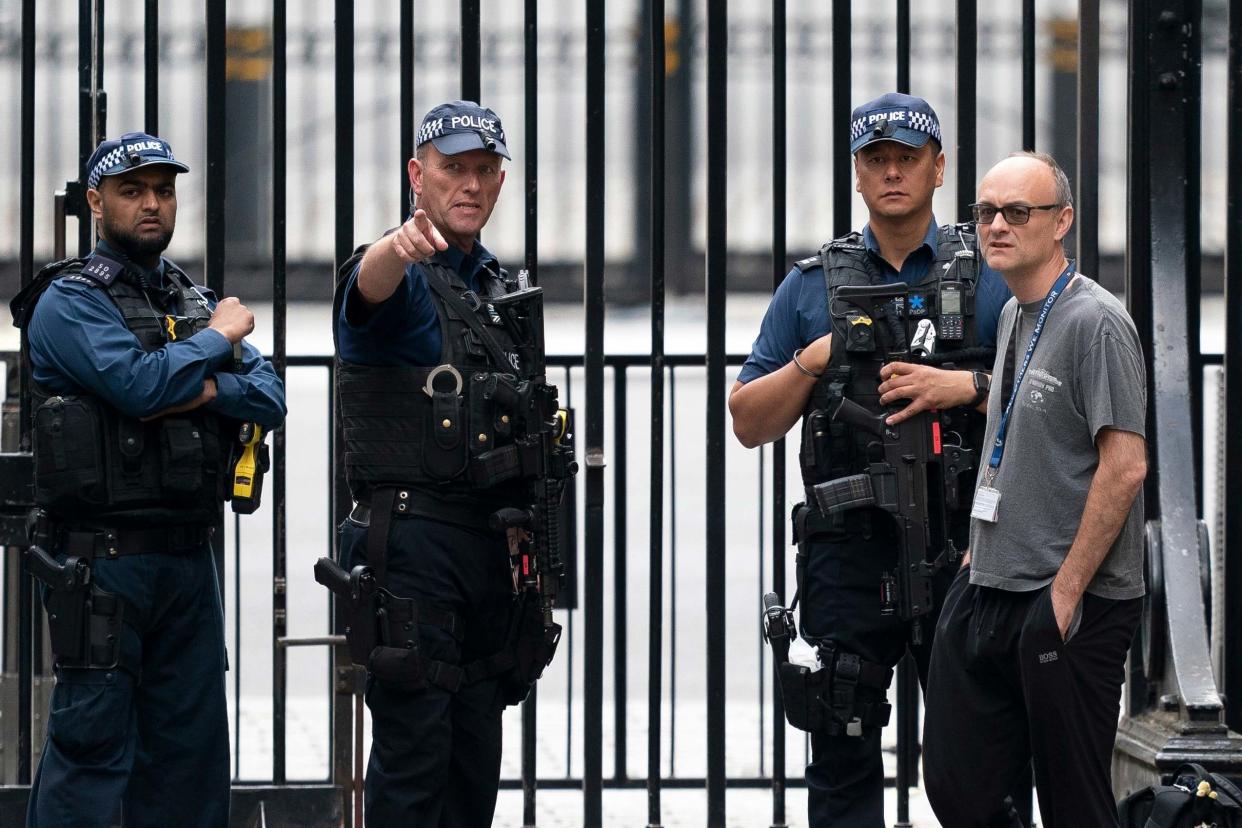 Dominic Cummings talks to police officers outside Downing Street: EPA