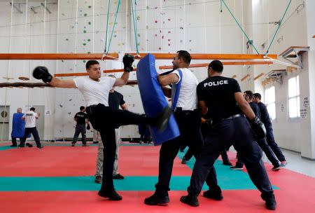 An Arab Israeli police recruit (L) takes part in physical training at Israeli police academy center in Beit Shemesh, Israel August 24, 2016. Picture taken August 24, 2016. REUTERS/Ammar Awad