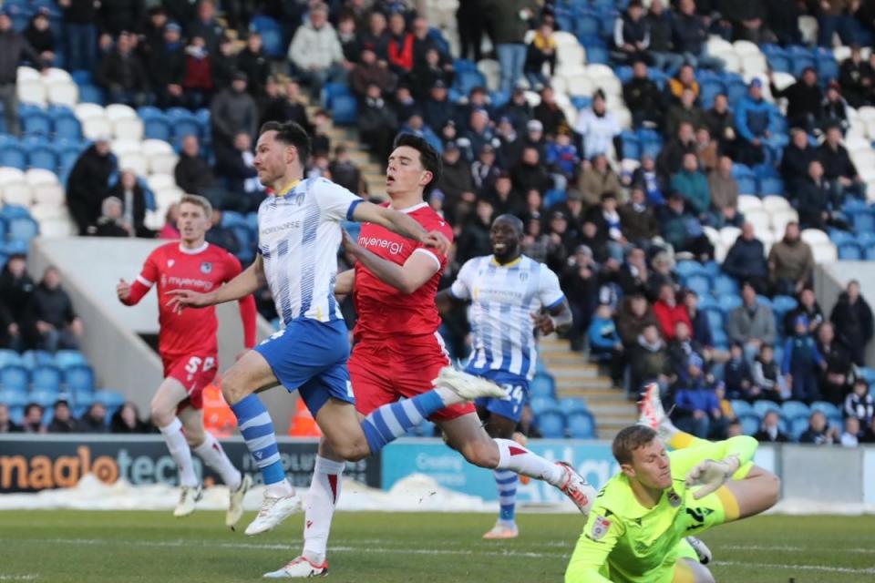 Cool finish - Tom Hopper lifts the ball past Grimsby Town goalkeeper Jake Eastwood to score for Colchester United <i>(Image: STEVE BRADING)</i>