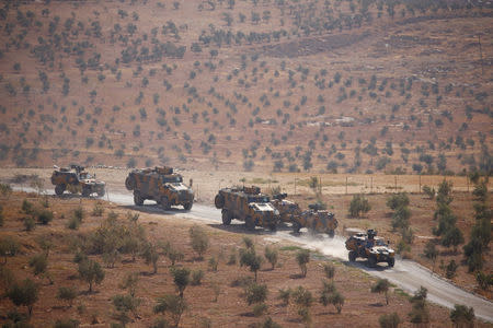 Turkish armoured military vehicles patrol on the Turkish-Syrian border line in Reyhanli, Hatay province, Turkey, October 8, 2017. REUTERS/Osman Orsal