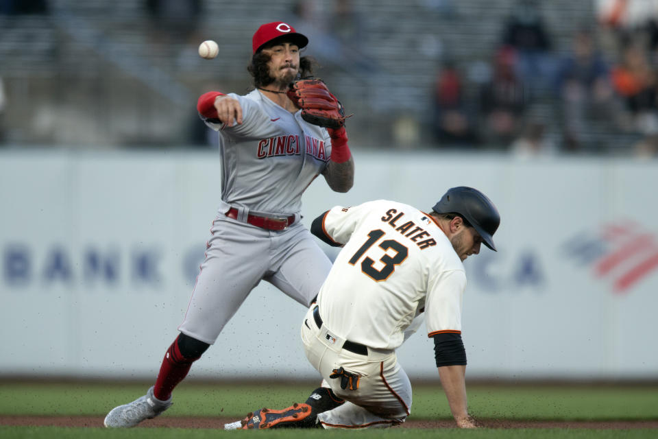 Cincinnati Reds second baseman Jonathan India (6) throws over San Francisco Giants' Austin Slater (13) too late to double up Donovan Solano at first during the first inning of a baseball game, Monday, April 12, 2021, in San Francisco, Calif. (AP Photo/D. Ross Cameron)