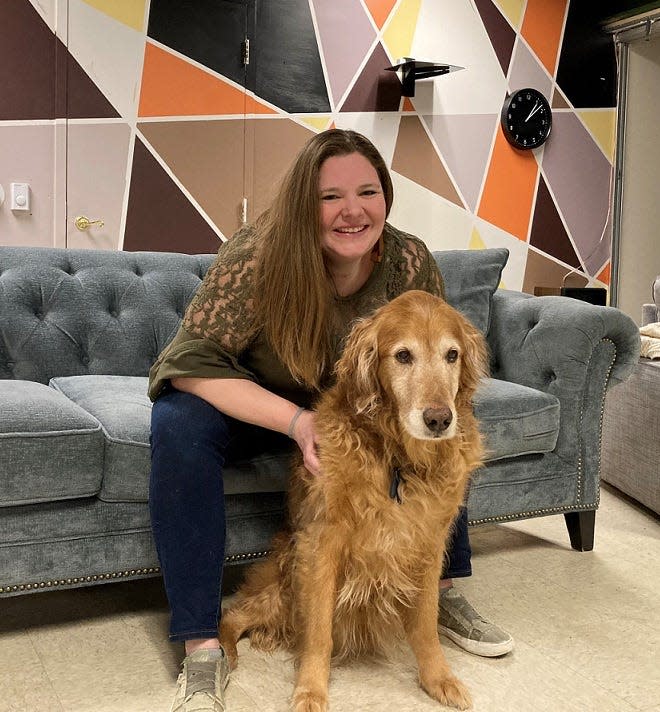Kristin Ream, director of senior high youth and communications at First Presbyterian Church in Granville, with her 11-year-old dog Tuke in the teen area of the West Broadway chuch. Ream often brings Tuke along to serve as emotional support when she meets with teens.