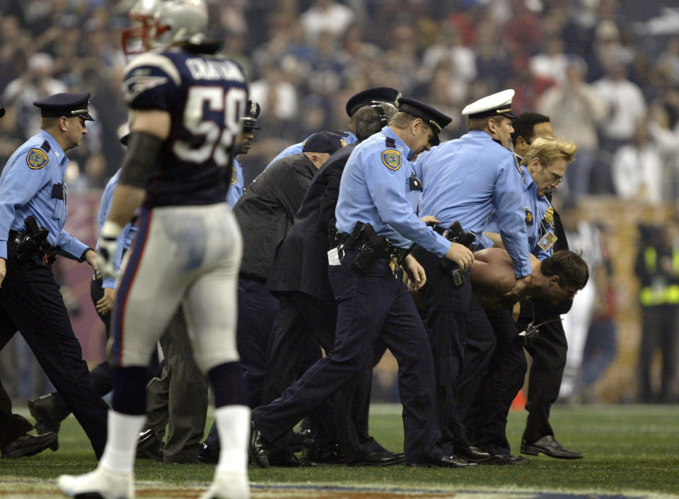 Mark Roberts is carried away after streaking Super Bowl XXVIII in Houston. (Getty Images)