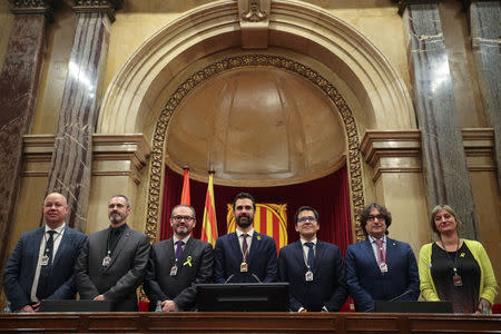 Roger Torrent (C), new Speaker of Catalan parliament, poses with members of new parliament's Governing body at the end of the first session of Catalan parliament in Barcelona, Spain, January 17, 2018. REUTERS/Albert Gea