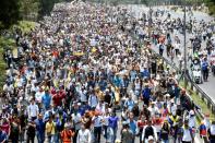 A crowd of opposition demonstrators marches through Caracas on April 26, 2017