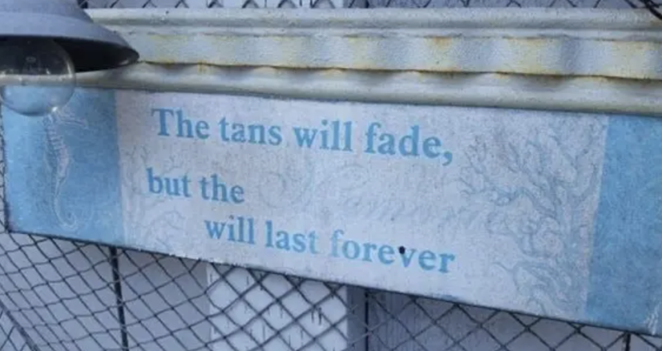 Sign reads "The tans will fade, but the memories will last forever" with part of the text obscured by snow