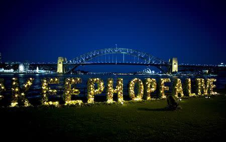 A floral tribute spelling out the words "keep hope alive" is staged, during a candlelight vigil held by Amnesty International for a pair of convicted Australian traffickers on death row in Indonesia, in front of the Sydney Harbour Bridge in Australia April 27, 2015. REUTERS/Jason Reed