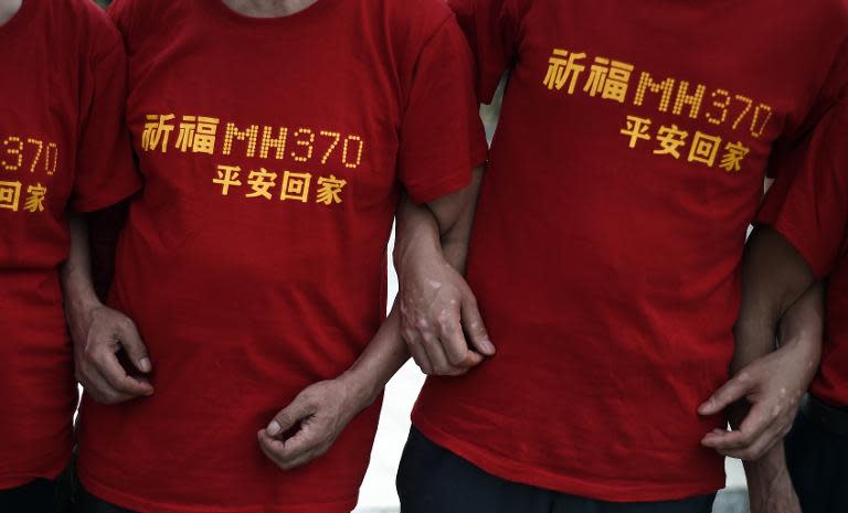 Relatives of Chinese passengers from missing Malaysia Airlines flight MH370 gather outside Malaysian Prime Minister Najib Razak's office in Putrajaya on February 18, 2015