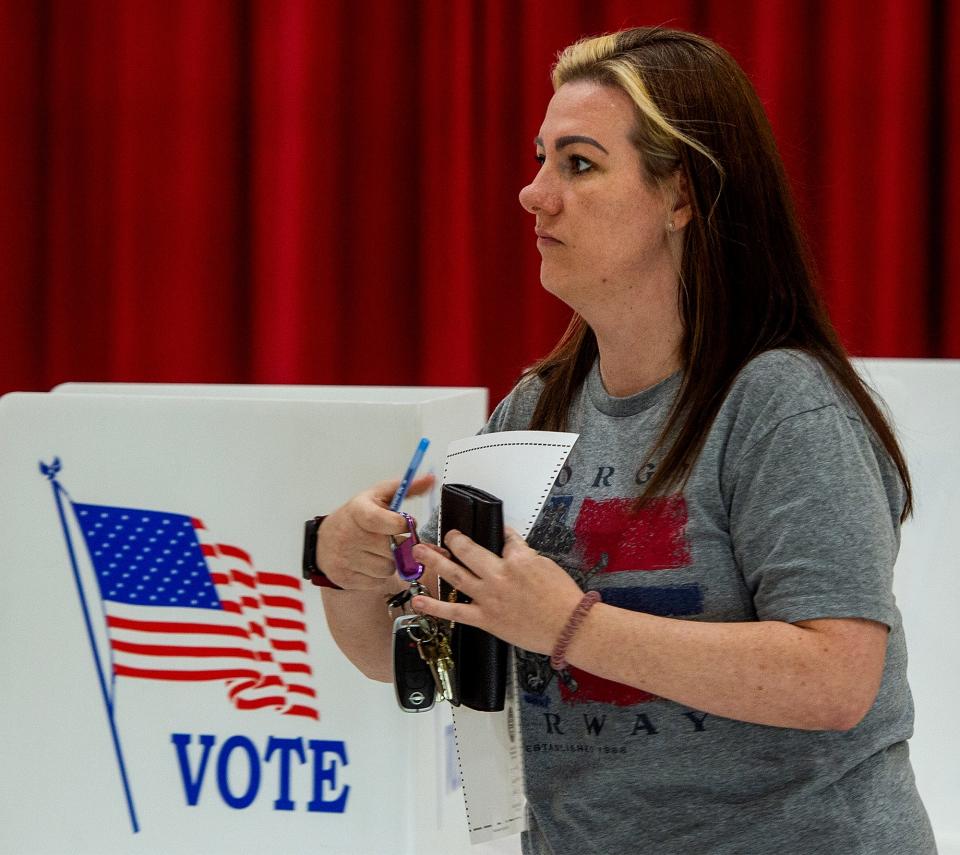 At the Snyder-Girotti School in Bristol Borough, resident Amanda Connelly heads to register her completed ballot, during the primary election in Bucks County, on Tuesday, May 16, 2023.