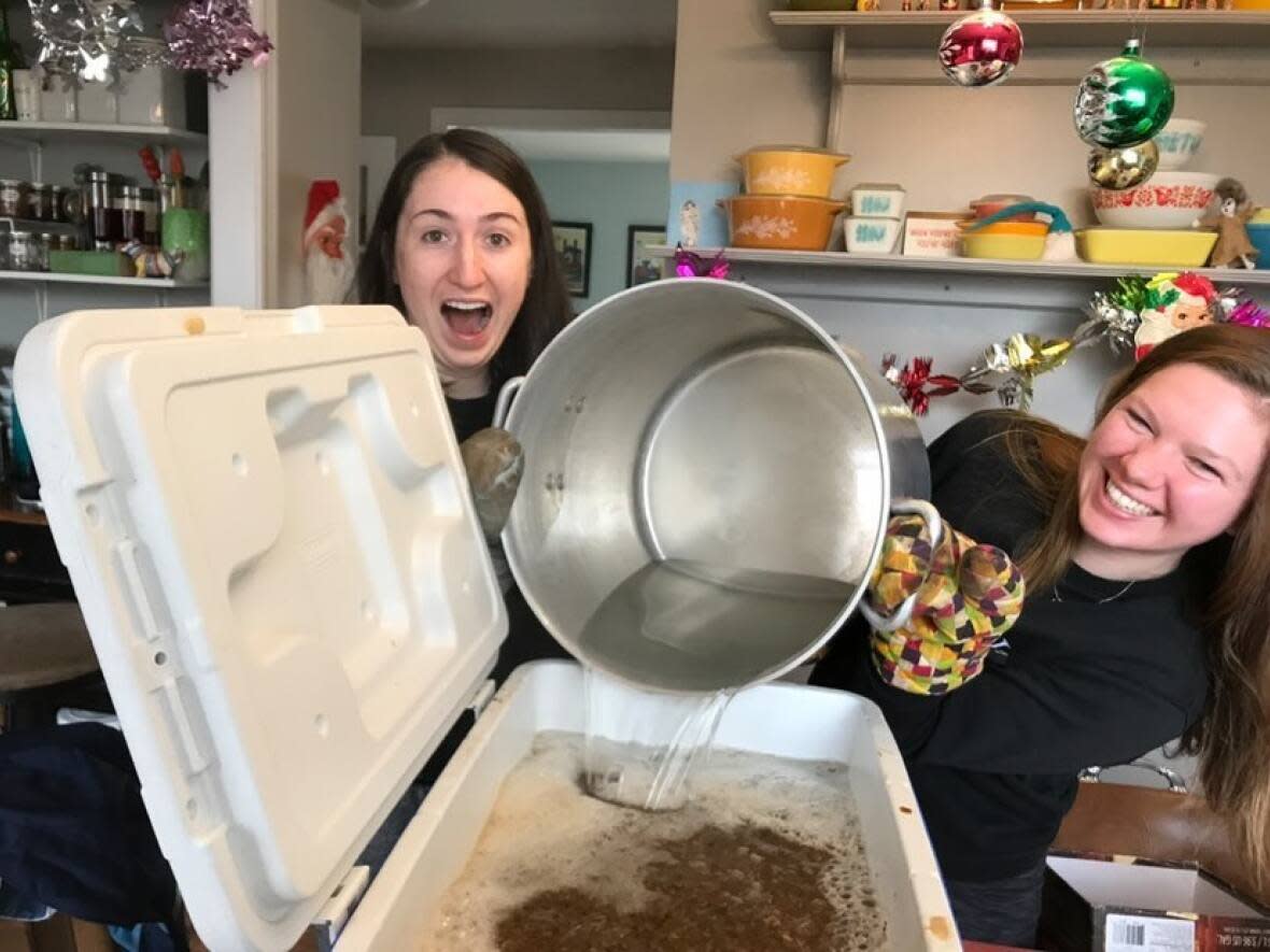 Chelsea King (left) and Natalie Dignam work on a new batch of beer. (Andie Bulman/CBC - image credit)