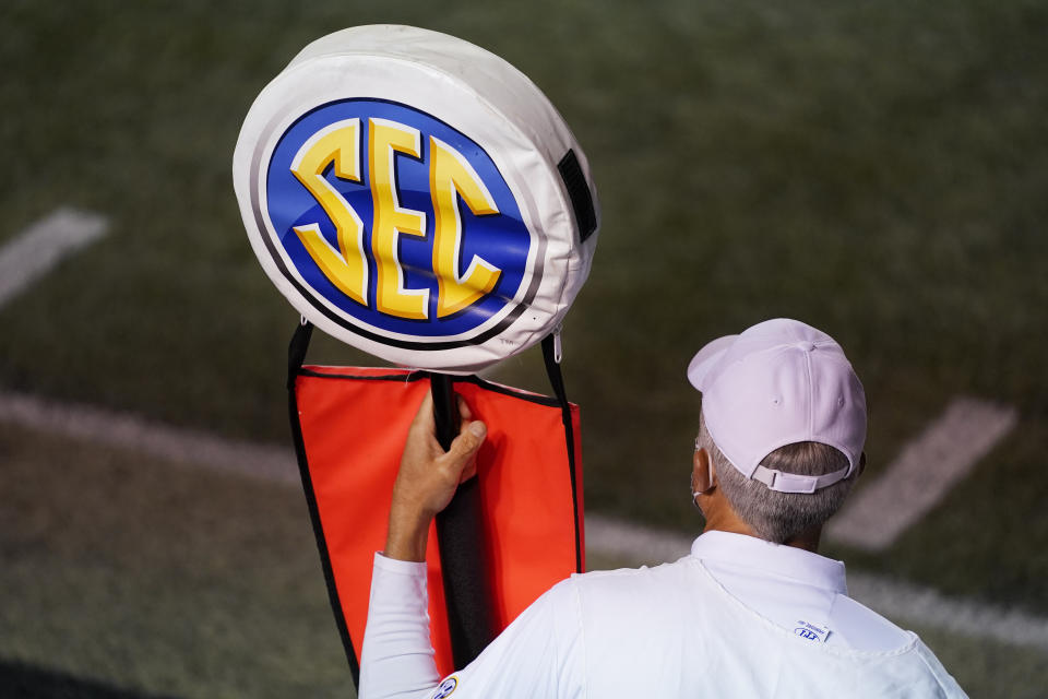 A member of the chain gang holds a marker with the SEC logo in the second half of an NCAA college football game between Vanderbilt and LSU Saturday, Oct. 3, 2020, in Nashville, Tenn. (AP Photo/Mark Humphrey)