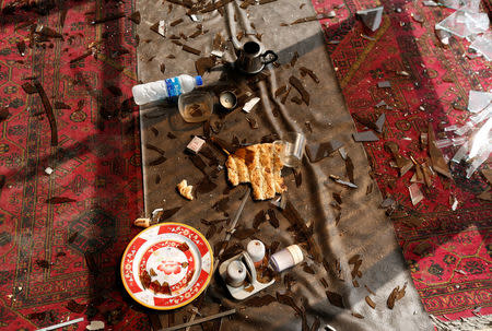 The remains of a customer's lunch is seen along broken glass and debris inside a resturant a day after a suicide attack in Kabul, Afghanistan July 24, 2016. REUTERS/Mohammad Ismail