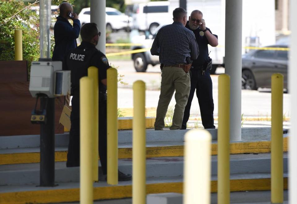 Law enforcement stands on the scene of an officer-involved shooting at Dedeaux Road and Three Rivers Road in Gulfport on Wednesday, May 22.