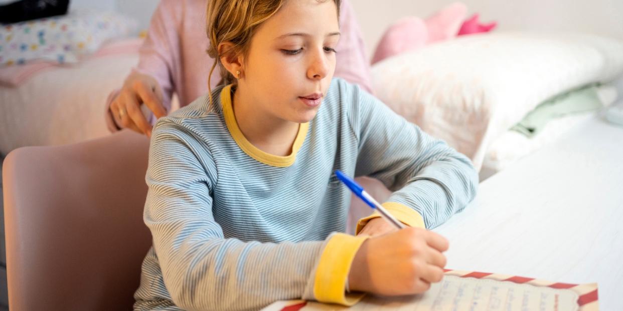 girl writing letter to santa truth about santa myth