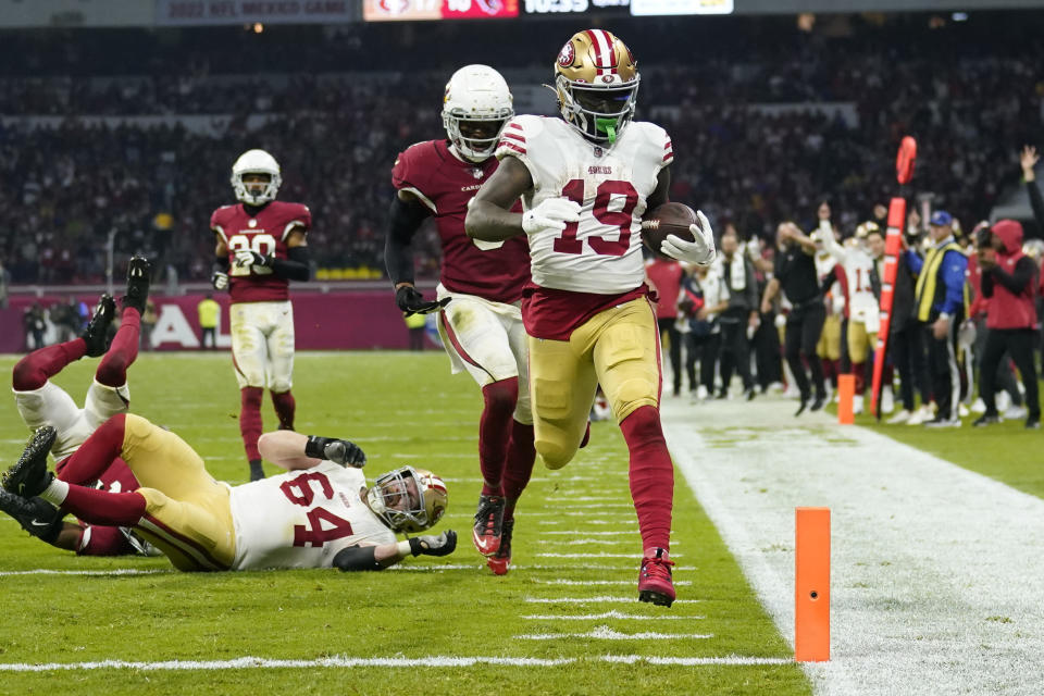 San Francisco 49ers wide receiver Deebo Samuel scores a touchdown during the second half of an NFL football game against the Arizona Cardinals, Monday, Nov. 21, 2022, in Mexico City. (AP Photo/Marcio Jose Sanchez)