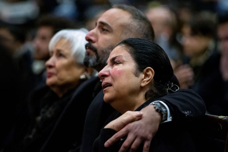 Mourners attend a memorial for the victims of a Ukrainian passenger plane which was shot down in Iran