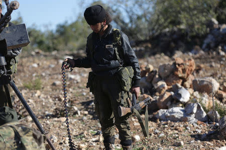 Turkish-backed Free Syrian Army fighter holds an ammunition belt near the city of Afrin, Syria February 19, 2018. REUTERS/Khalil Ashawi