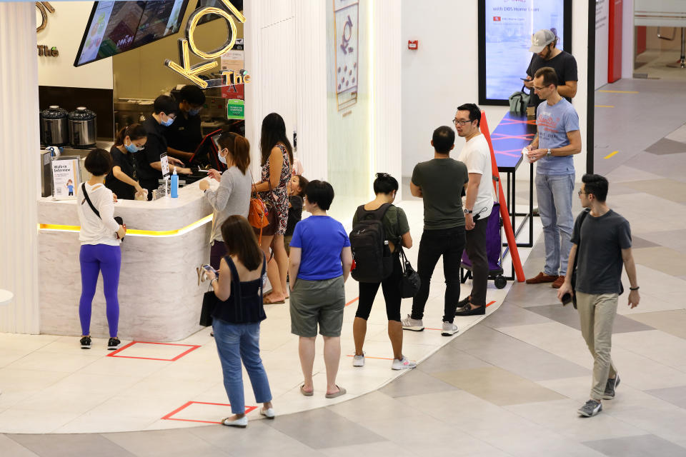 SINGAPORE - People queue to buy bubble tea with safety distancing markers in place at a shopping mall. (Photo by Suhaimi Abdullah/Getty Images)