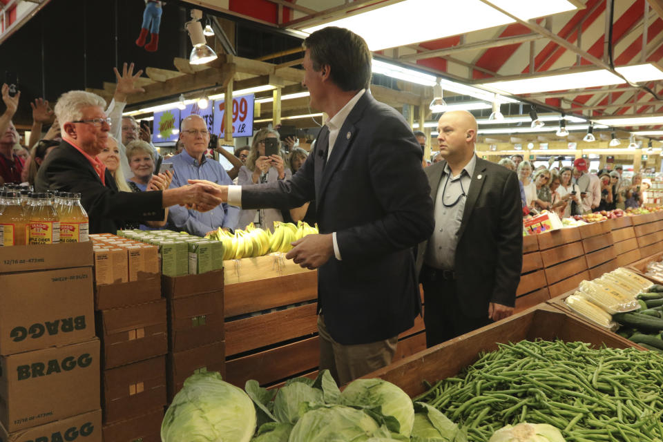 Virginia Gov. Glenn Youngkin, center, greets supporters as he arrives to sign the budget bill at a ceremony at a grocery store Tuesday June 21, 2022, in Richmond, Va. The Virginia General Assembly passed the budget earlier in the week. (AP Photo/Steve Helber)