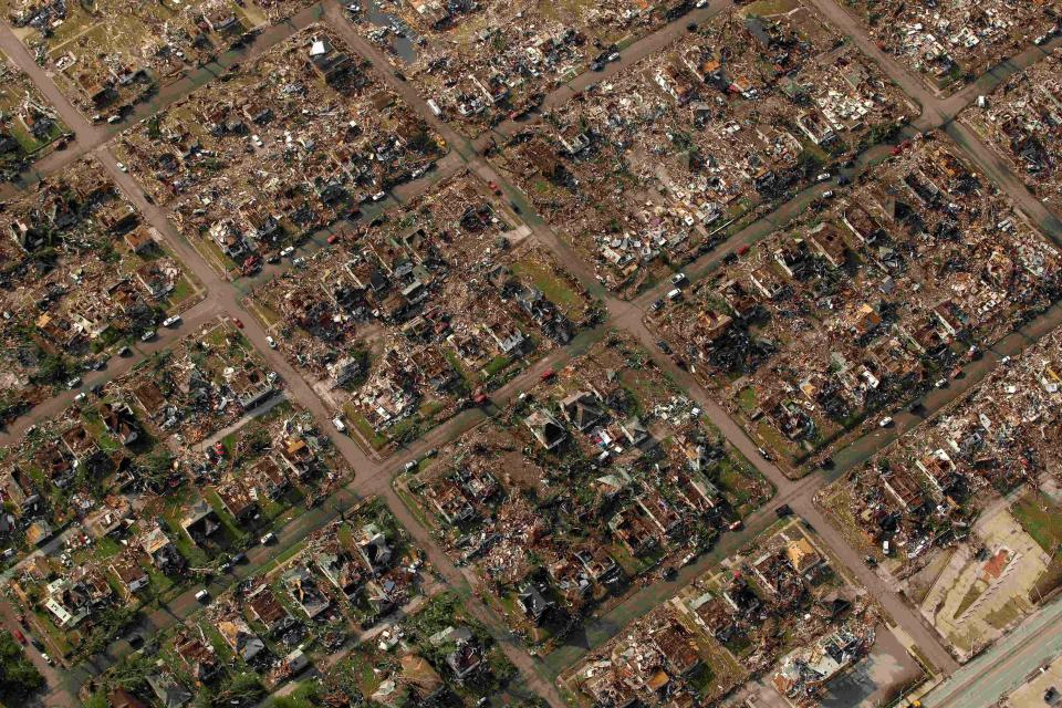 A neighborhood destroyed by a tornado is seen in Joplin, Mo., May 24, 2011. A new study says warming will fuel more supercells or tornados in the United States and that those storms will move eastward from their current range.