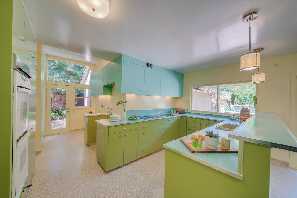 The dwelling has a unique green kitchen.