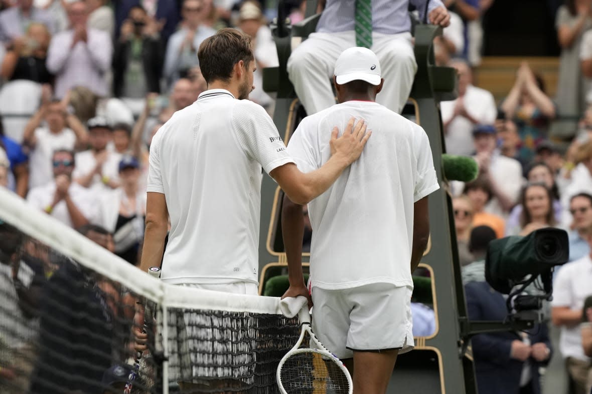 Russia’s Daniil Medvedev, left, shakes hands with Christopher Eubanks of the US after beating him in their men’s singles match on day ten of the Wimbledon tennis championships in London, Wednesday, July 12, 2023. (AP Photo/Alastair Grant)