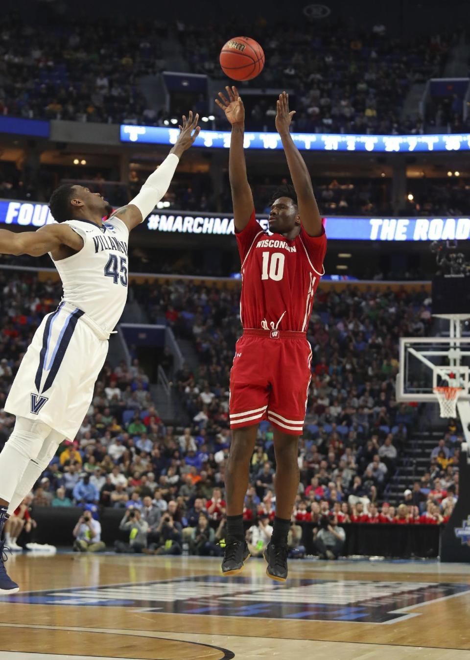 Wisconsin forward Nigel Hayes (10) takes a jump shot against Villanova forward Darryl Reynolds (45) during the first half of a second-round men's college basketball game in the NCAA Tournament, Saturday, March 18, 2017, in Buffalo, N.Y. (AP Photo/Bill Wippert)