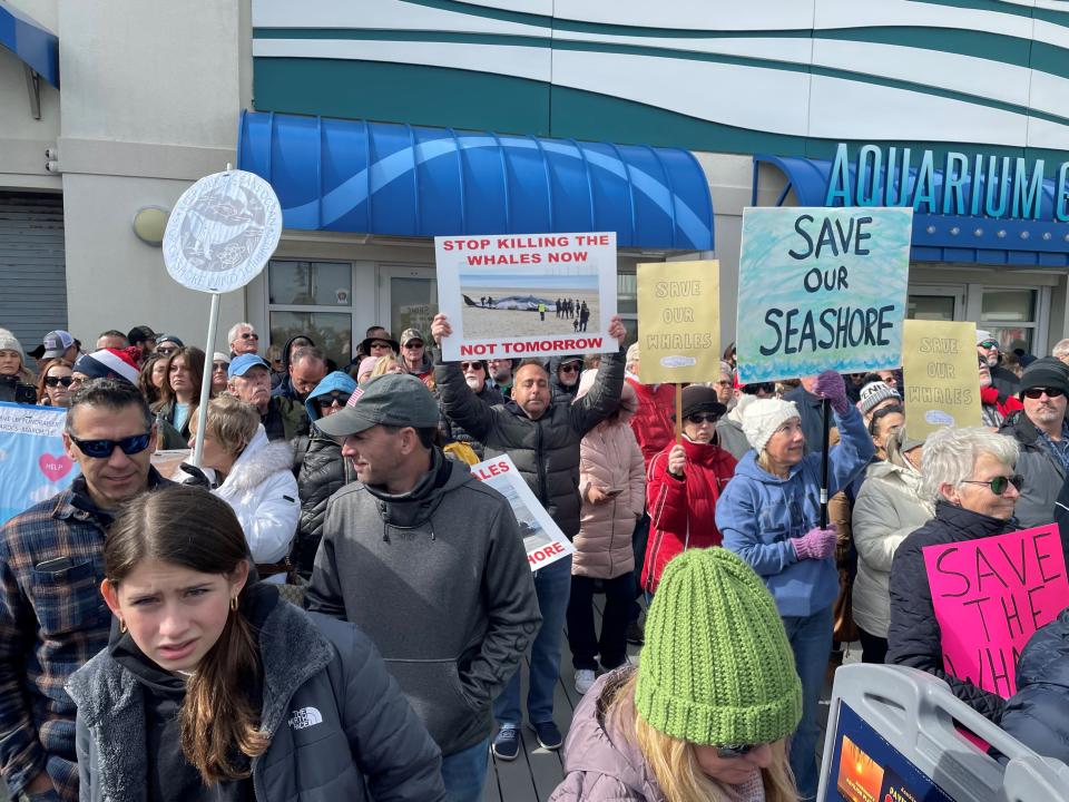 Protesters hold signs at a "Save the Whales" rally in Point Pleasant Beach on Sunday, Feb. 19, 2023.