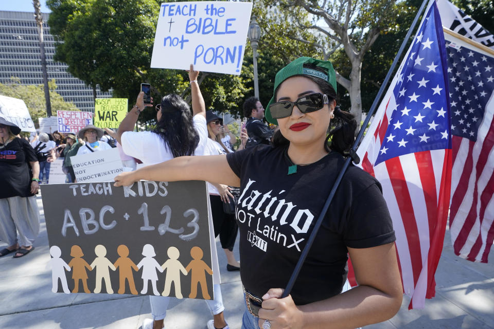 A demonstrator with Leave Our Kids Alone holds a sign at a rally opposing Los Angeles Unified School District's LGBTQ policies in Los Angeles, Tuesday, Aug. 22, 2023. (AP Photo/Damian Dovarganes)