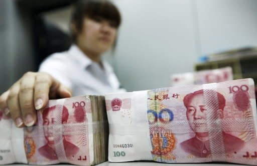 A bank clerk counts stacks of Chinese 100 yuan notes. China's move to allow more competition in its state-dominated banking sector revives a reform shelved for nearly a decade and defies expectations of a policy freeze before leadership change this year