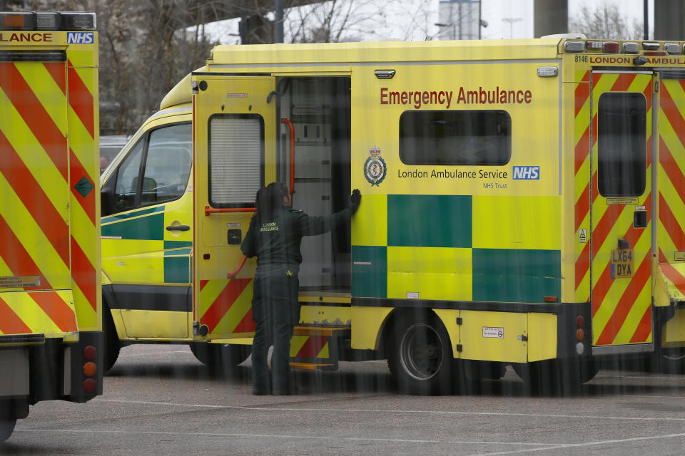 LONDON, ENGLAND - MARCH 29: London Ambulance staff stand next to service vehicles at the new NHS Nightingale Hospital at ExCeL London on March 29, 2020 in London, England. The field hospital will initially contain 500 beds with ventilators and oxygen and will have the capacity to eventually hold up to 4,000 COVID-19 patients. (Photo by Hollie Adams/Getty Images)