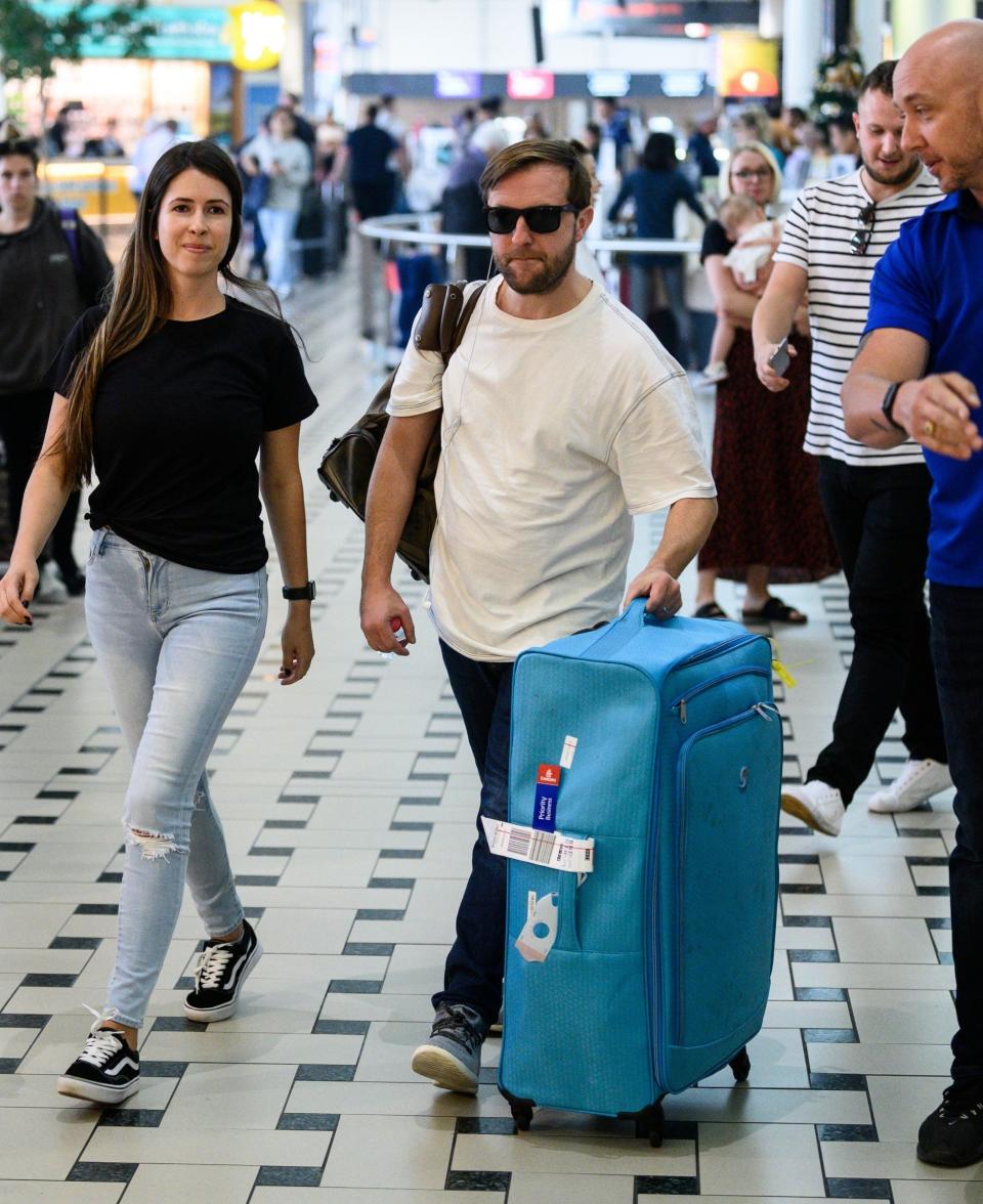 Landed: Andrew Maxwell arriving at Brisbane Airport today (Rex Features)