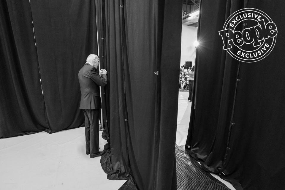 Biden peeks through the pipe and drape to see the crowd and event space before speaking at a town hall at Clinton College in Rock Hill, South Carolina, on Aug. 29, 2019.