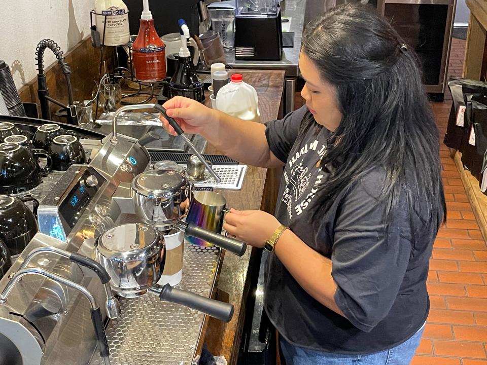 Shanna Lee of Harlem Java House prepares a latte flavored with pistachio syrup, the most recent syrup added to the dozens the coffeeshop already offers.