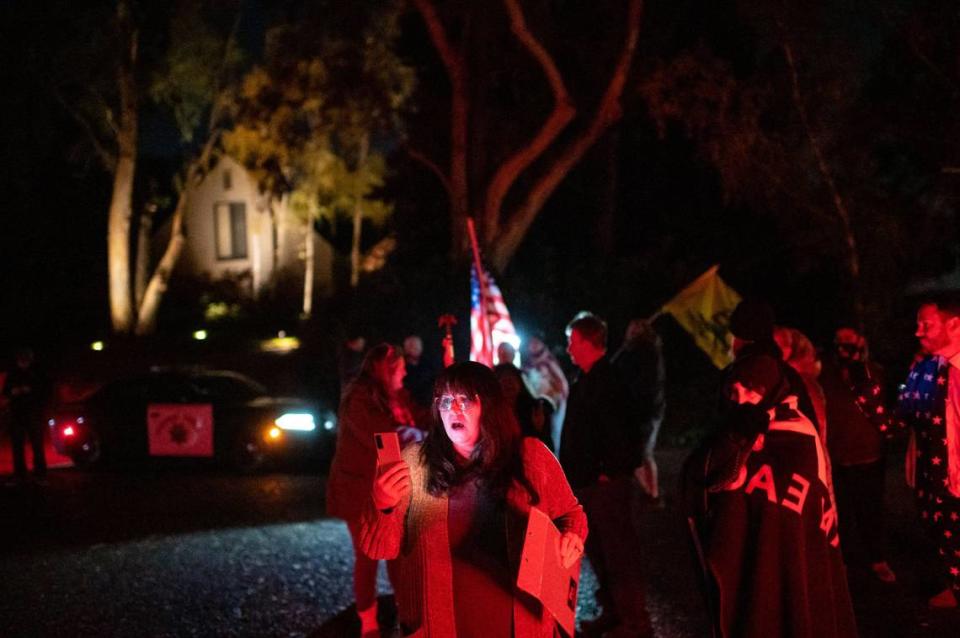 Republican Chris Bish, who lost her race for the U.S. House of Representatives to represent California’s 6th Congressional District, speaks as she streams to social media outside the gate of California Gov. Gavin Newsoms home in protest on the first night of a 10 p.m. to 5 a.m. curfew Saturday, Nov. 21, 2020, in Fair Oaks. Gov. Newsom announced the overnight stay-at-home order, restricting non-essential activities, for most of California in an effort to slow the spread of the COVID-19.