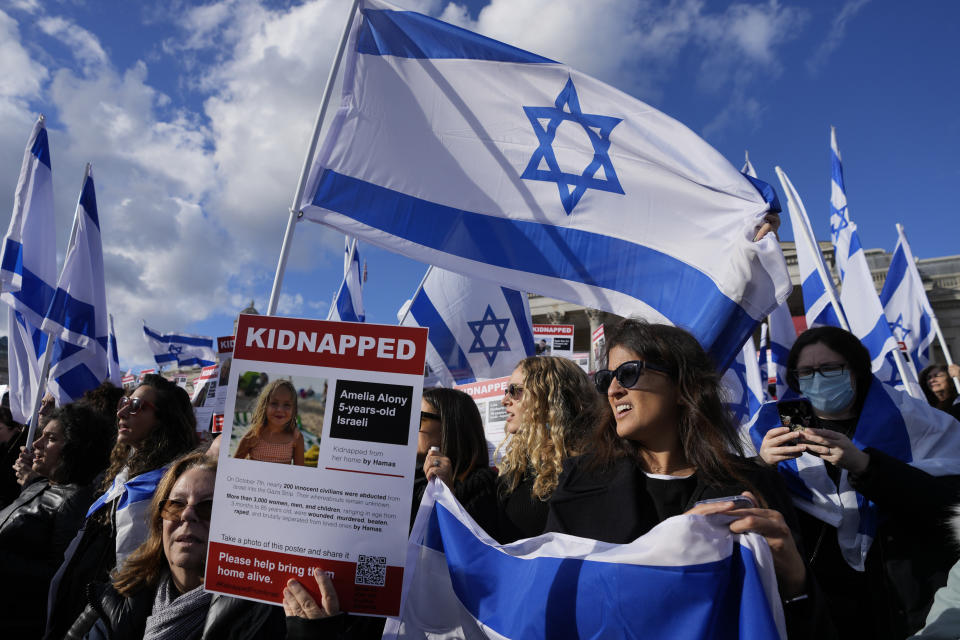 Israeli supports show placards with the faces and names of people believed to be taken hostage and held in Gaza, during a protest in Trafalgar Square, London, Sunday, Oct. 22, 2023. They are demanding the release of all hostages allegedly taken by the militant group Hamas. (AP Photo/Frank Augstein)