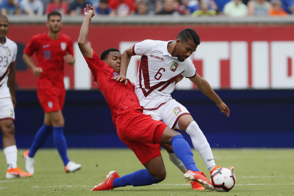 Venezuela midfielder Yangel Herrera (6) and United States midfielder Weston Mckennie (8) vie for the ball during the first half of an international friendly soccer match, Sunday, June 9, 2019, in Cincinnati. (AP Photo/John Minchillo)