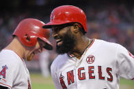 Los Angeles Angels' Brian Goodwin, right, celebrates his solo home run with Kole Calhoun during the first inning of a baseball game against the Houston Astros Saturday, Sept. 28, 2019, in Anaheim, Calif. (AP Photo/Mark J. Terrill)