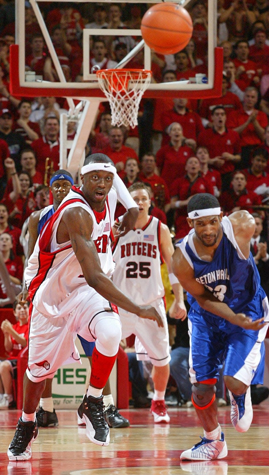 Rutgers' Herve Lamizana, and Seton Hall's Damion Fray chase a loose ball in the 2004 classic at the RAC.