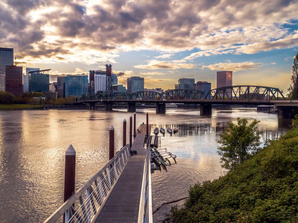 A view of Portland oregan with view of lake and skyline and bridge