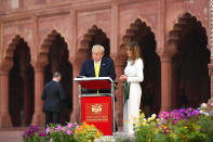 US President Donald Trump signs a guest book as First Lady Melania Trump looks on while visiting the Taj Mahal in Agra on February 24, 2020. (Photo by Mandel NGAN / AFP) (Photo by MANDEL NGAN/AFP via Getty Images)